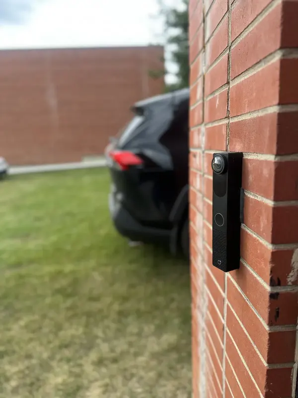 Video intercom installed on the corner of a brick commercial building